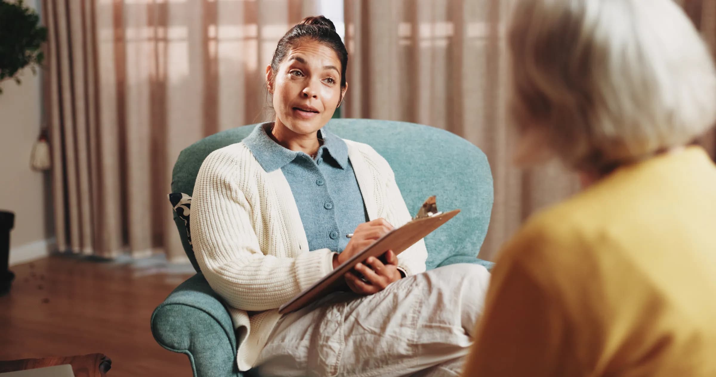 Professional counselor listening to senior client in a comfortable office setting